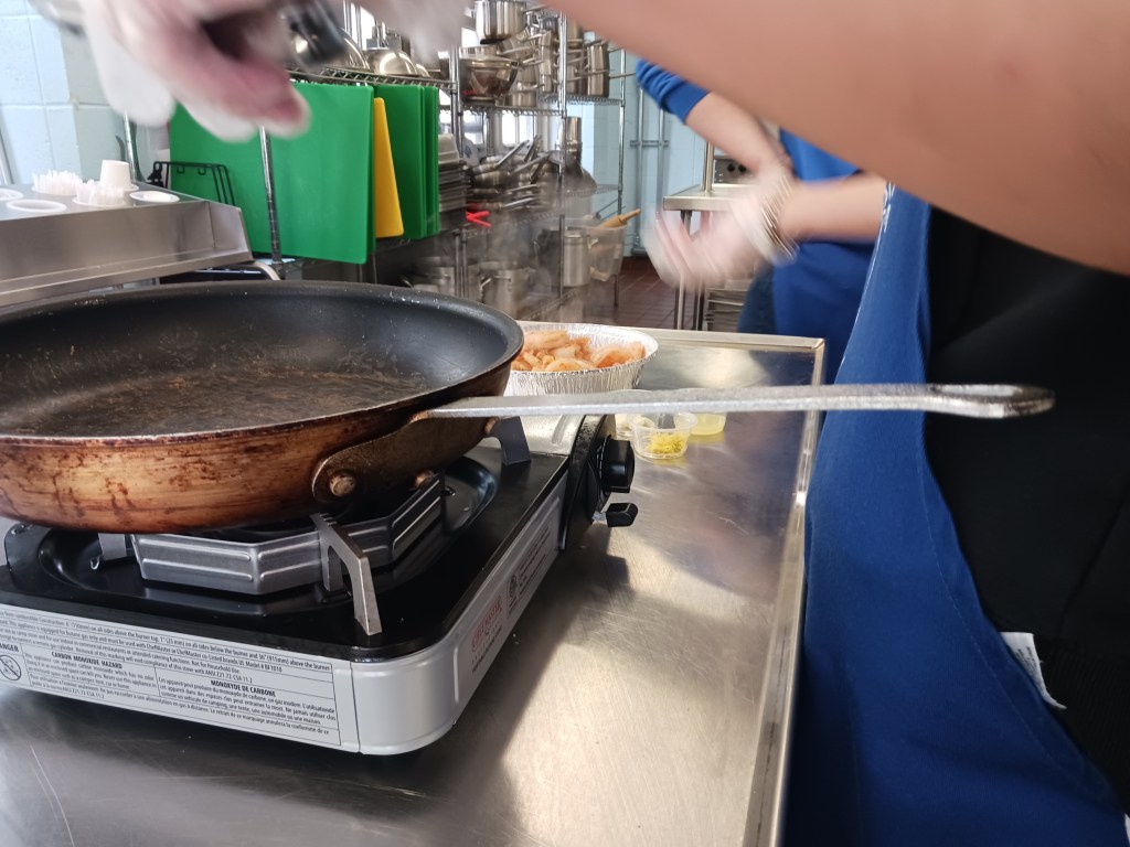 Sauteing jumbo shrimp in garlic oil and lemon zest
